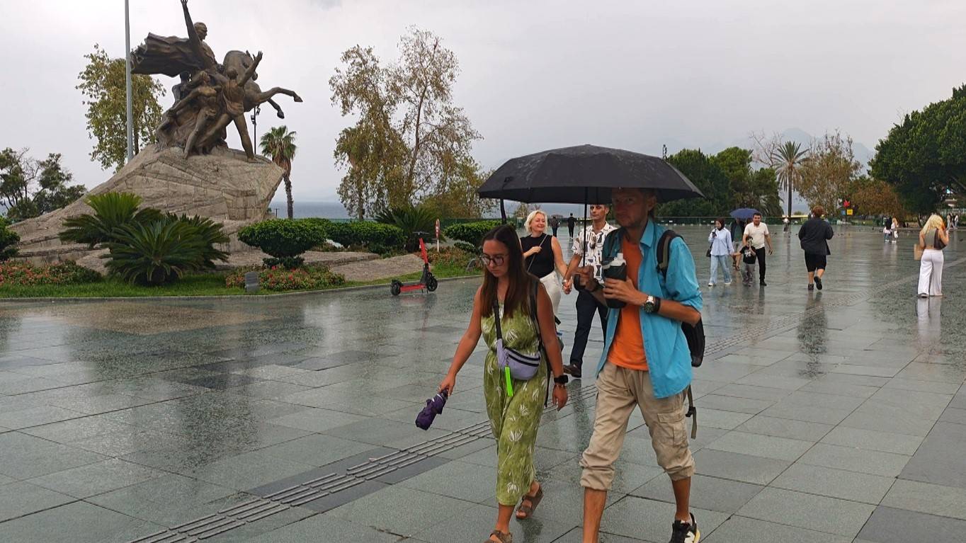 Sağanak yağış turistleri durduramadı: Antalya'da geziler şemsiyeli devam etti
